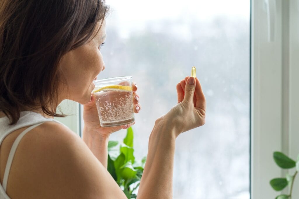 Woman takes pill with omega-3